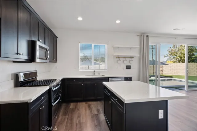 a kitchen with a sink stove and microwave