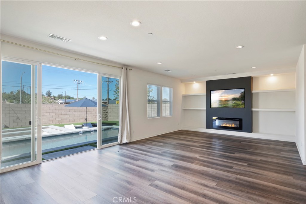 9605 Bonsai Lane Riverside, CA 92508 - Photo 10 of 41 a view of empty room with wooden floor and fireplace