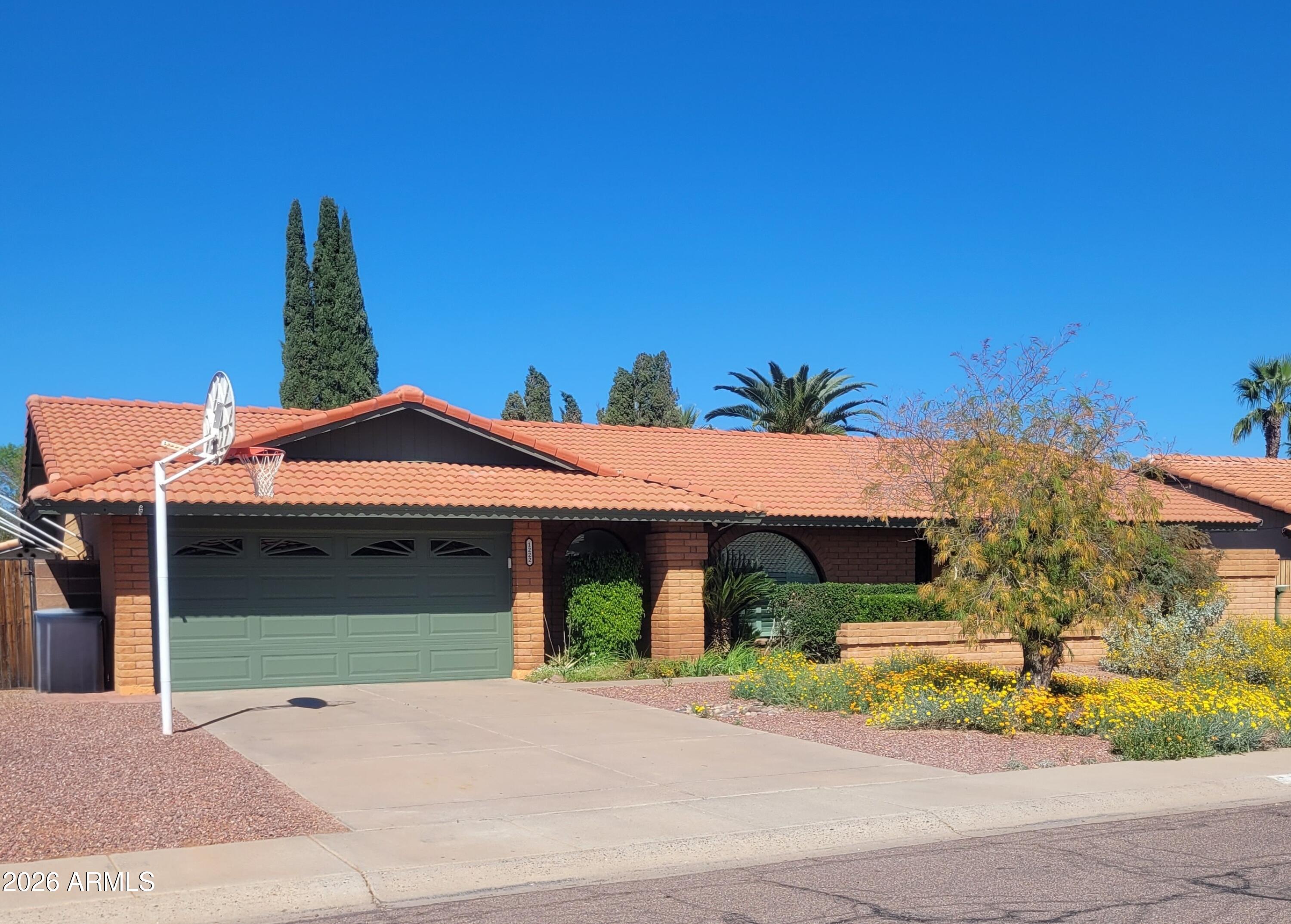 1222 East Louis Way Tempe, AZ 85284 - Photo 1 of 39 a front view of a house with a yard and garage