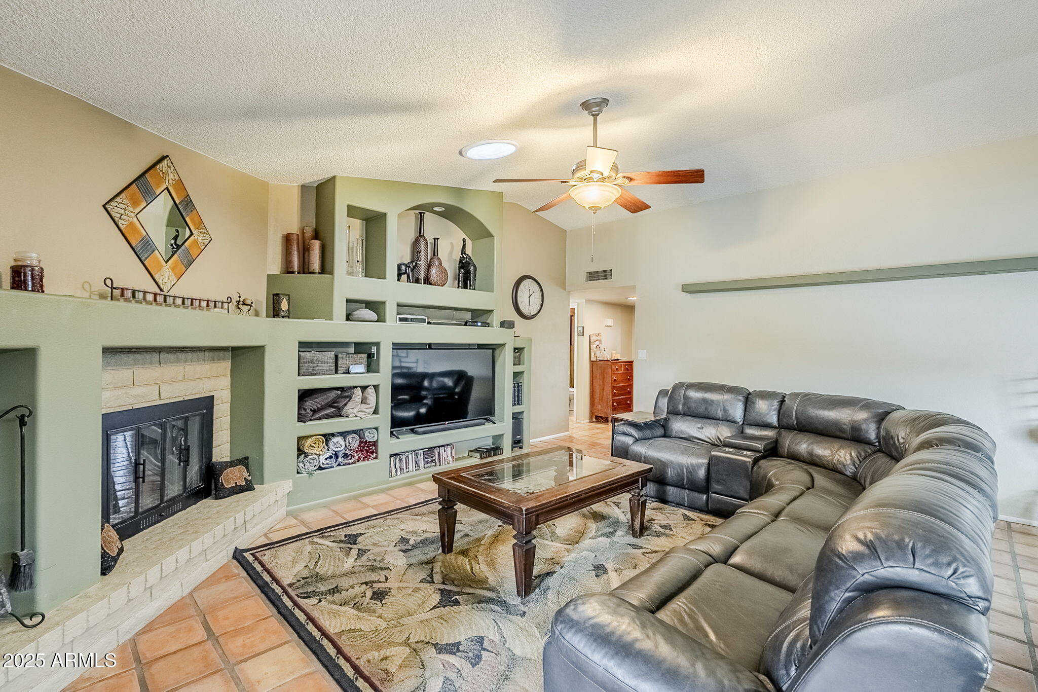1222 East Louis Way Tempe, AZ 85284 - Photo 18 of 39 a living room with furniture a fireplace and a ceiling fan