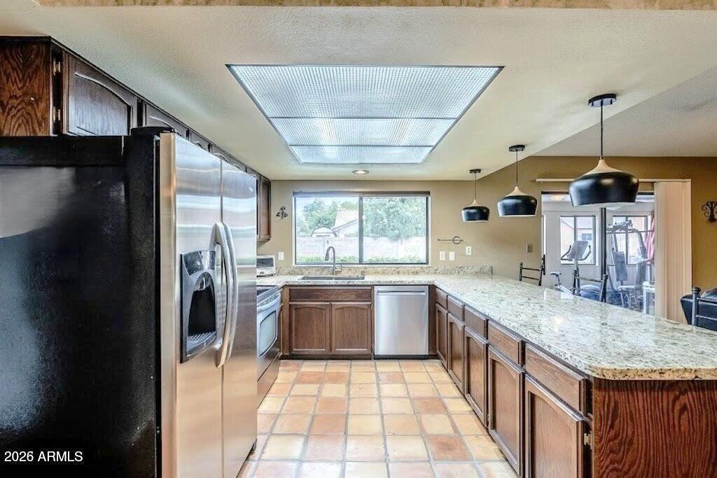 1222 East Louis Way Tempe, AZ 85284 - Photo 21 of 39 a large kitchen with stainless steel appliances granite countertop a sink and a refrigerator