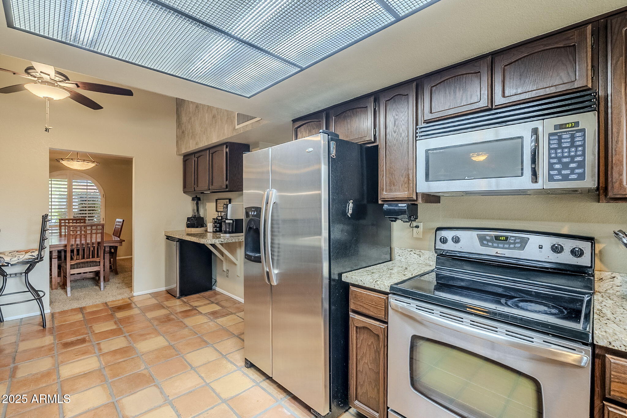 1222 East Louis Way Tempe, AZ 85284 - Photo 23 of 39 a kitchen with stainless steel appliances granite countertop a stove a refrigerator and a oven