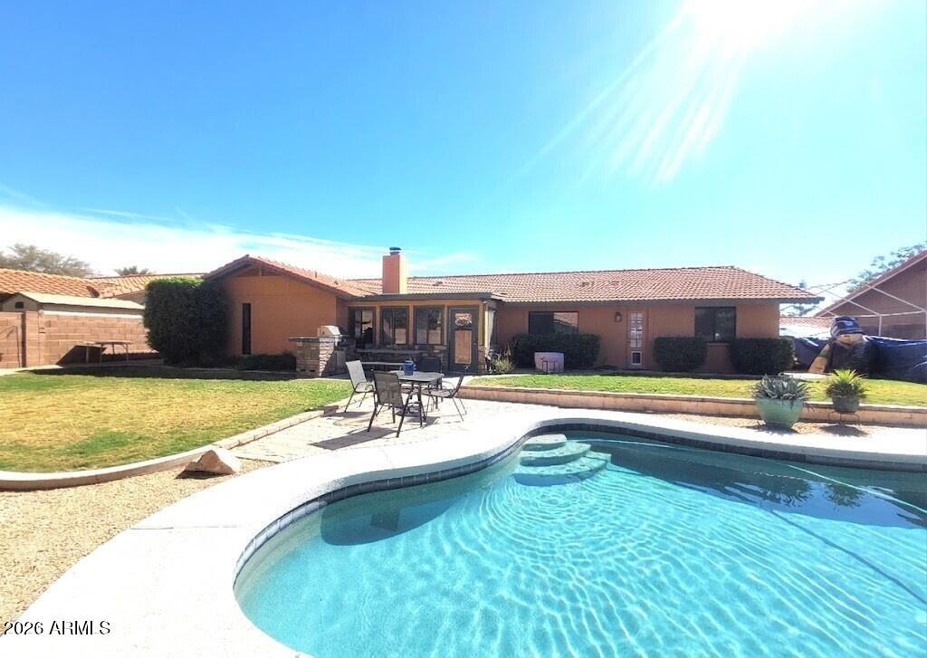1222 East Louis Way Tempe, AZ 85284 - Photo 2 of 39 a view of a swimming pool with an outdoor seating