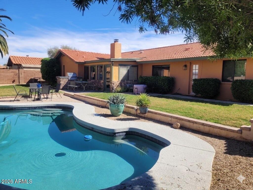 1222 East Louis Way Tempe, AZ 85284 - Photo 34 of 39 a view of a house with backyard swimming pool and sitting area