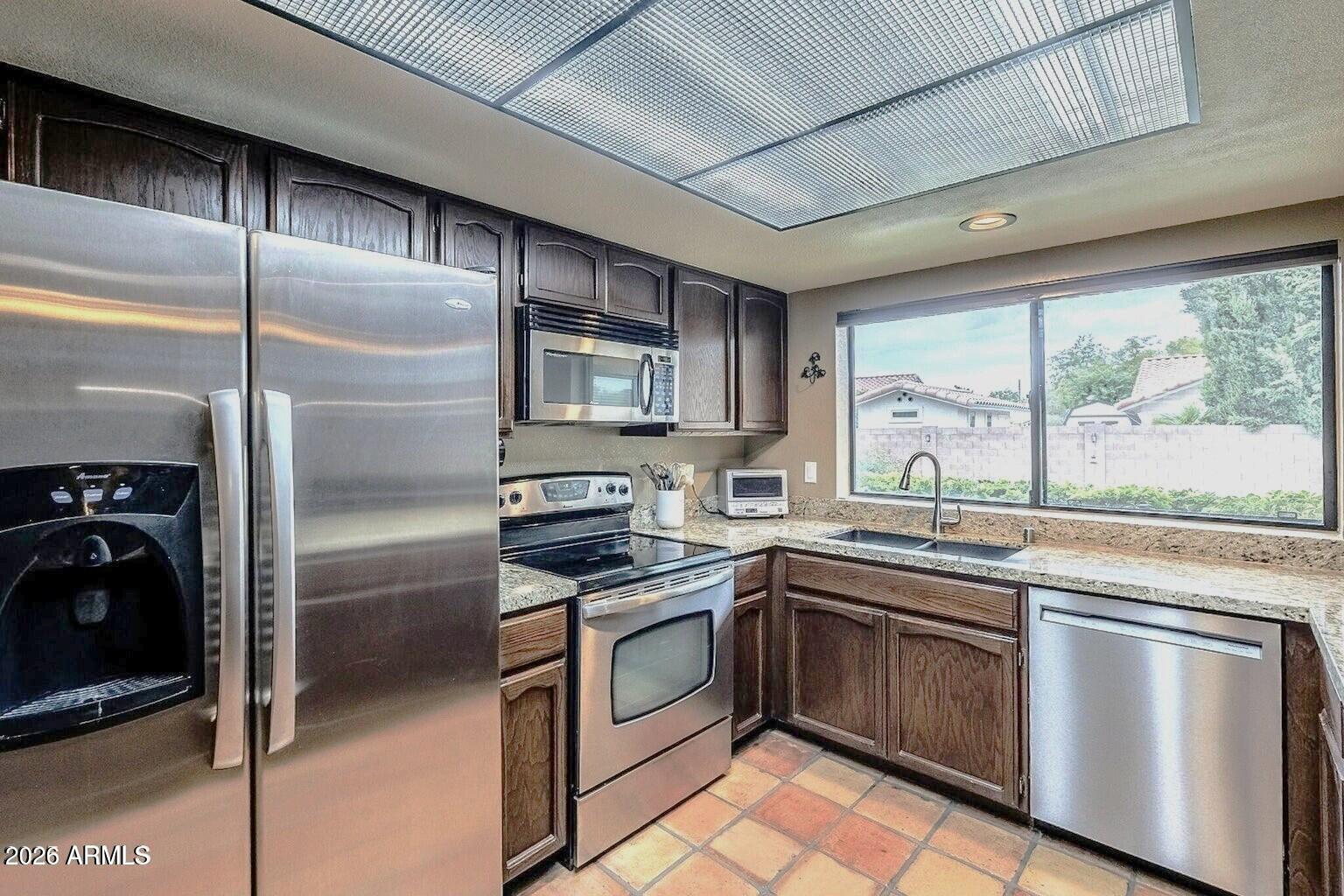 1222 East Louis Way Tempe, AZ 85284 - Photo 3 of 39 a kitchen with a sink stove and refrigerator