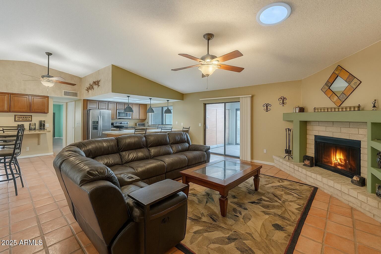 1222 East Louis Way Tempe, AZ 85284 - Photo 4 of 39 a living room with furniture a fireplace and a table