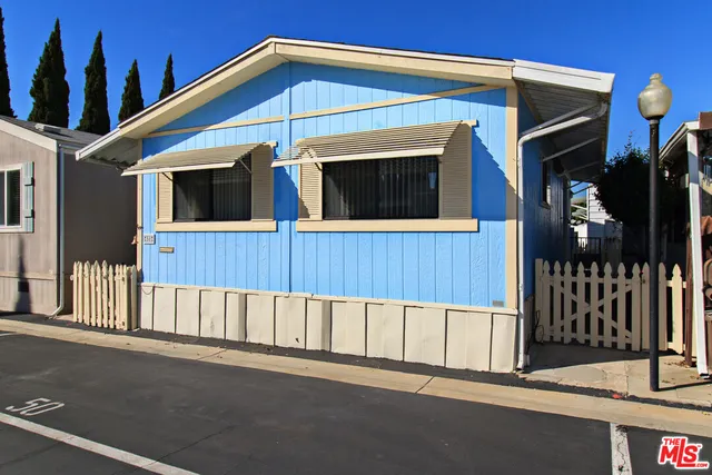 a view of a house with a small yard