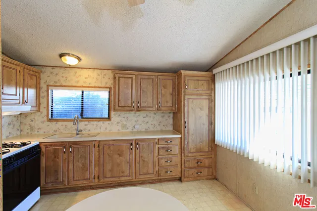 a bathroom with a granite countertop sink a mirror and a bathtub