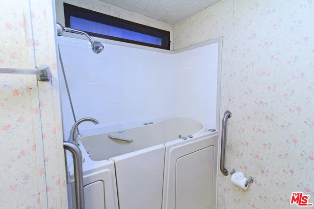 a bathroom with a sink a toilet and a shower