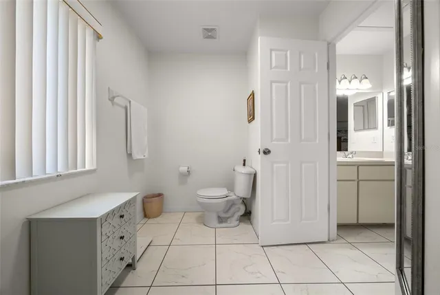 a bathroom with a toilet sink and shower