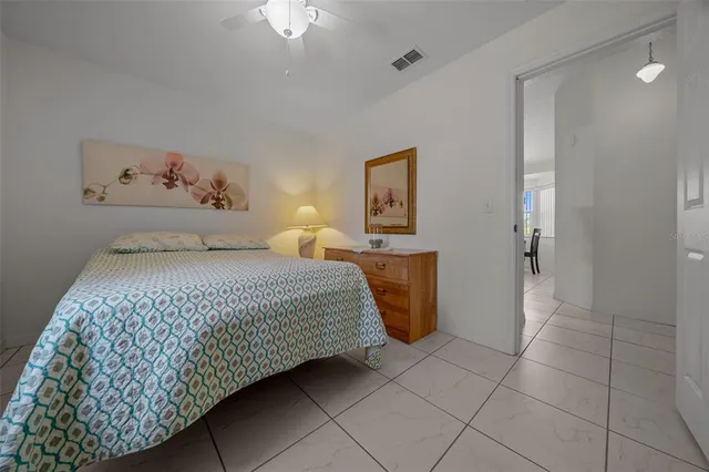 a bedroom with a bed and a painting on the wall