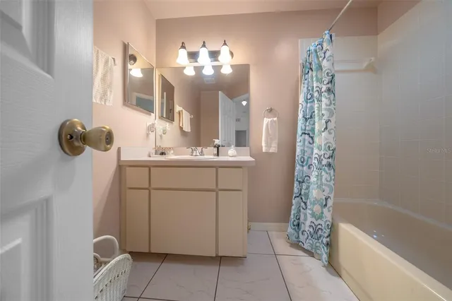 a bathroom with a sink mirror and shower