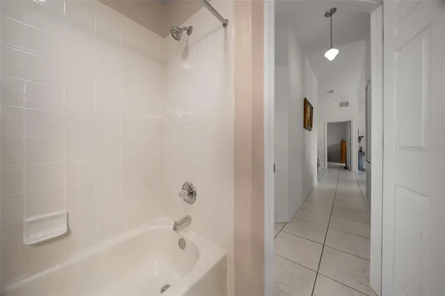 a bathroom with a bathtub and shower