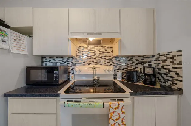 a stove top oven sitting inside of a kitchen