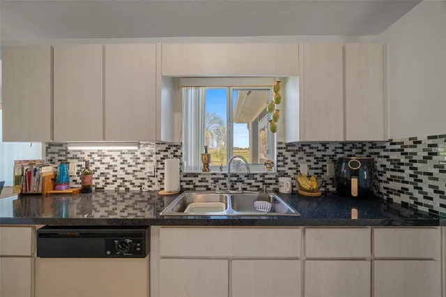 a kitchen with stainless steel appliances a sink stove and refrigerator
