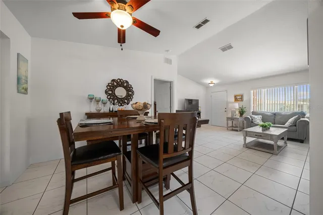a view of a dining room and kitchen with furniture window and wooden floor
