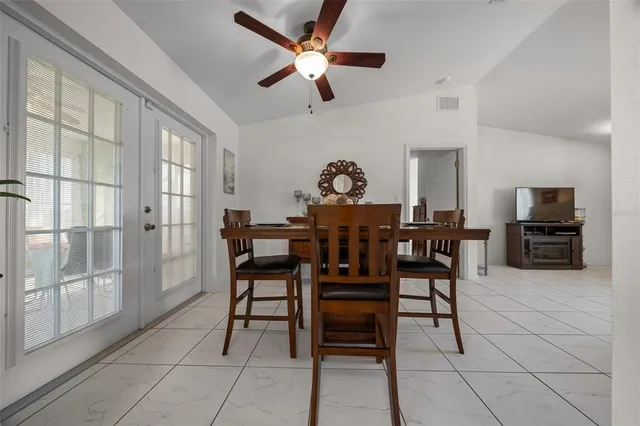 a view of a livingroom with furniture and a dining table