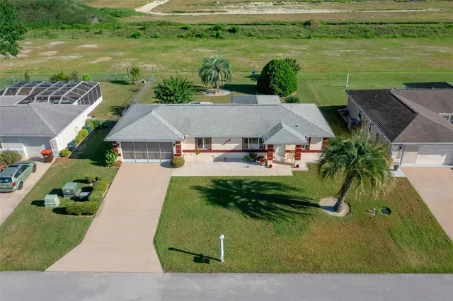 an aerial view of a house with a yard basket ball court and outdoor seating