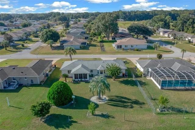 an aerial view of residential houses with outdoor space and parking