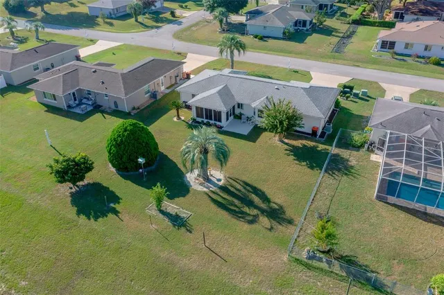 an aerial view of residential house with outdoor space and swimming pool