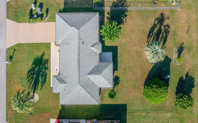 an aerial view of a house with swimming pool and red space