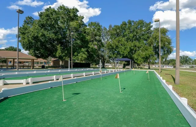 a view of a swimming pool with outdoor seating