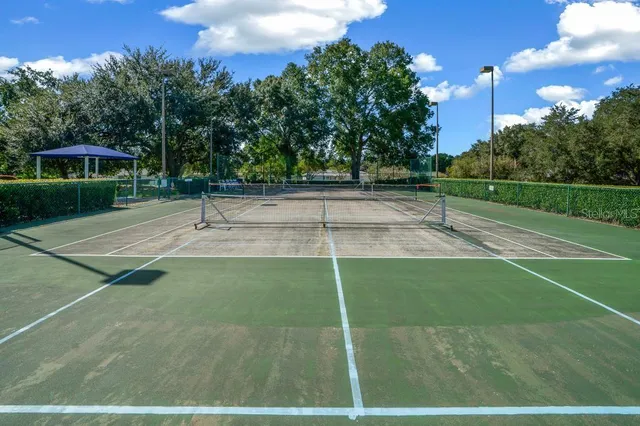 an aerial view of a house with a yard basket ball court and outdoor seating