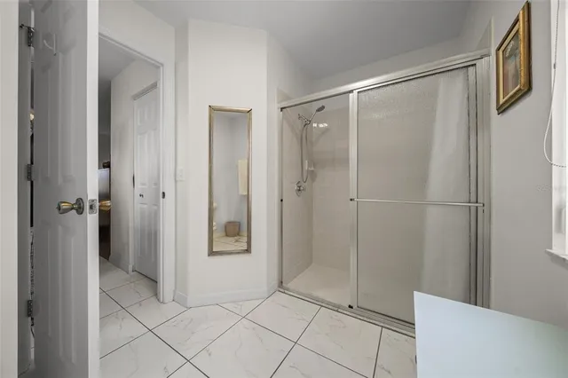 a bathroom with a shower and a glass door