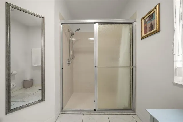 a bathroom with a glass shower door