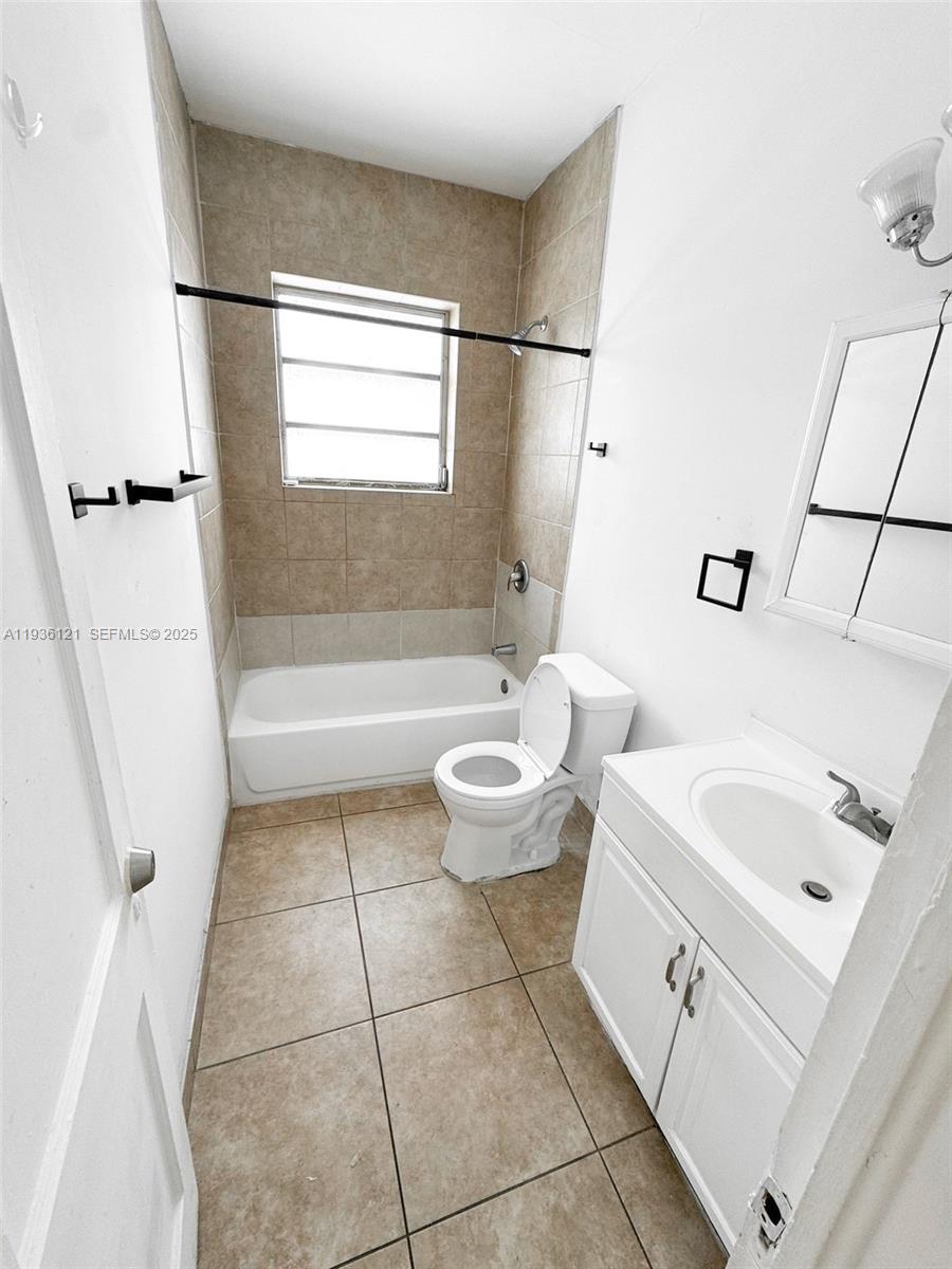 711 Northwest 1st Street, Unit 3 Miami, FL 33128 - Photo 7 of 14 a bathroom with a sink a toilet and a bathtub