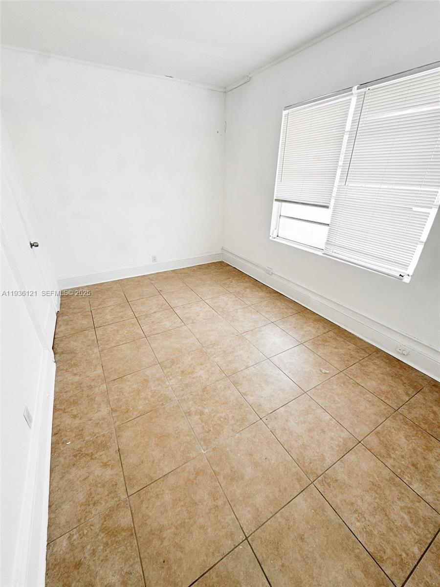 711 Northwest 1st Street, Unit 3 Miami, FL 33128 - Photo 8 of 14 an empty room with a empty space and window