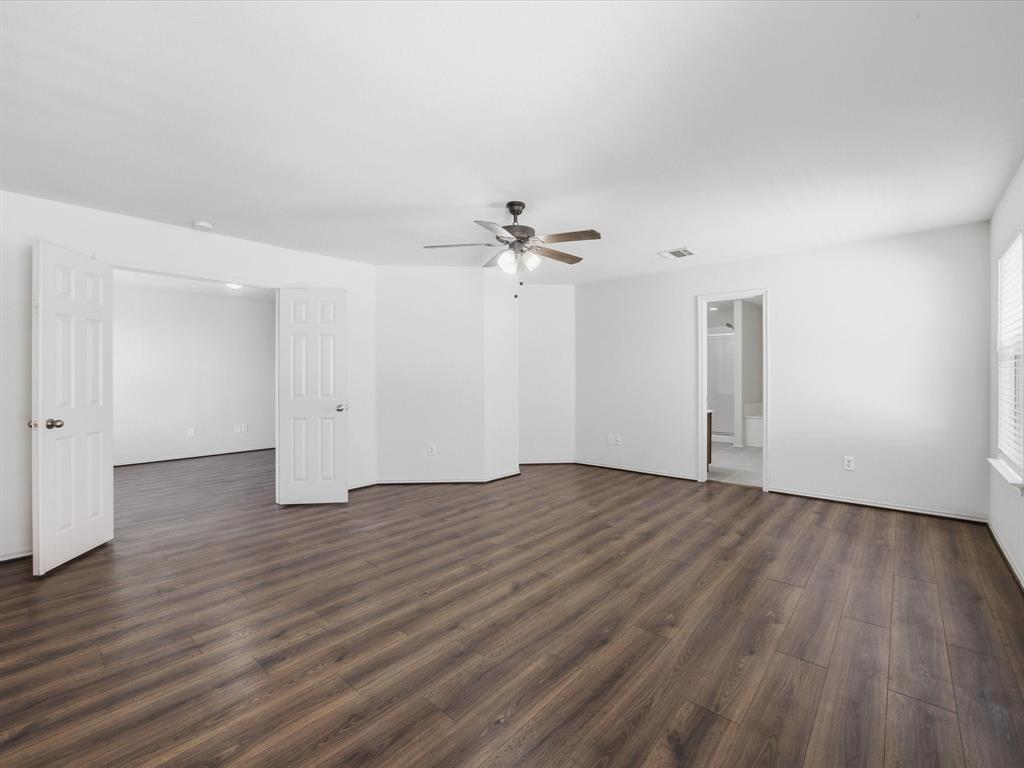 2021 Laughlin Road Fort Worth, TX 76177 - Photo 22 of 40 a view of an empty room with wooden floor