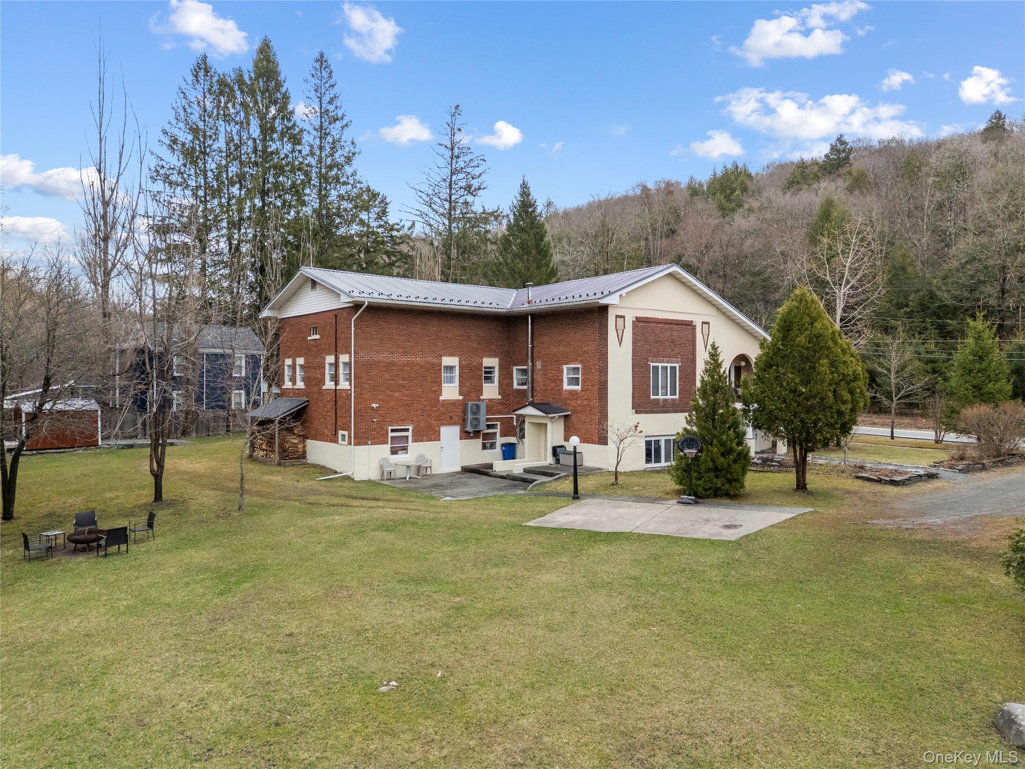 23 Cooley Road Parksville, NY 12768 - Photo 15 of 43 a view of a house with backyard porch and sitting area