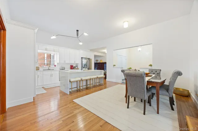 a living room with kitchen island furniture and a wooden floor
