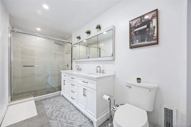 a bathroom with a toilet a sink and mirror