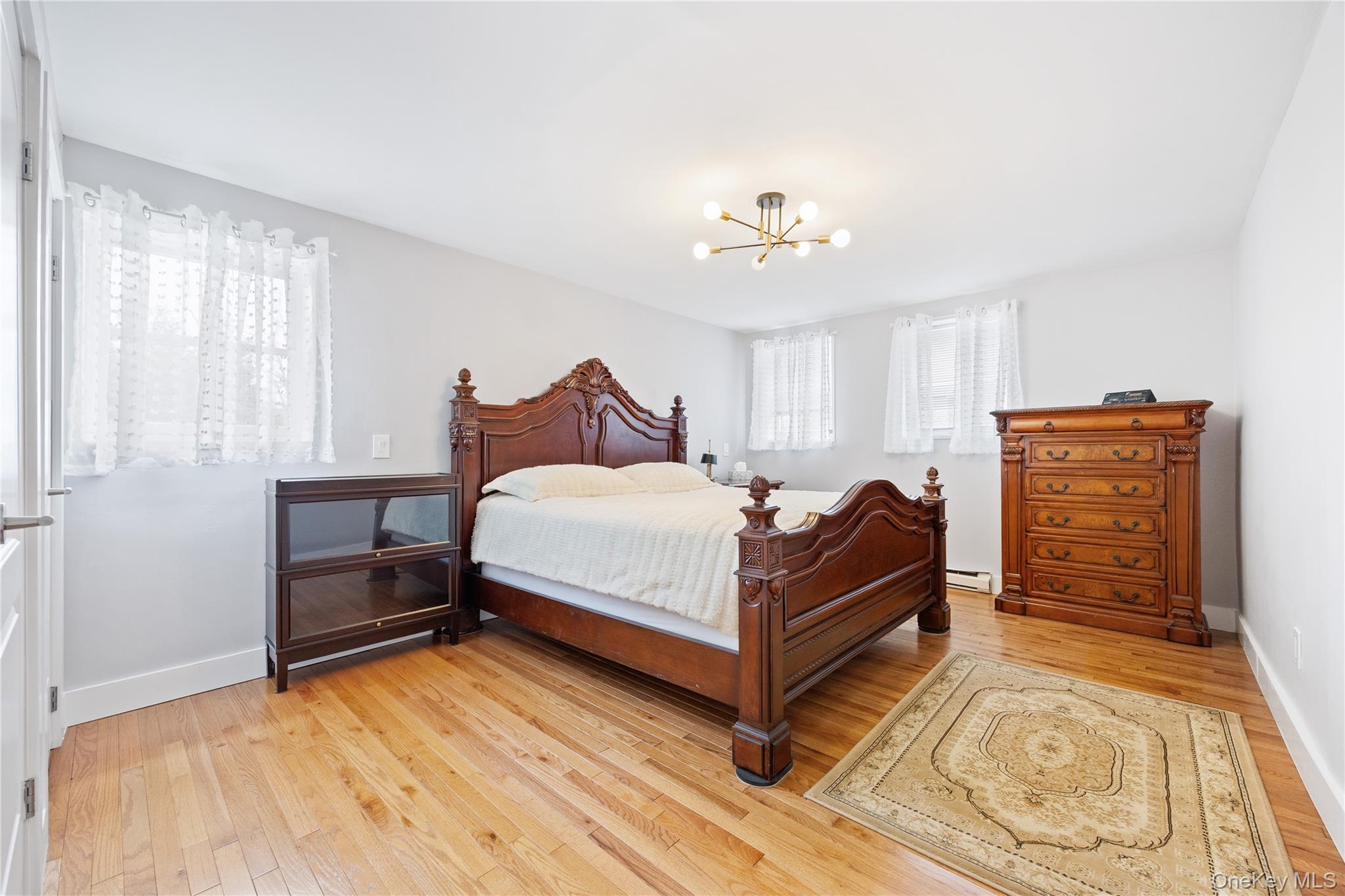 23 Cooley Road Parksville, NY 12768 - Photo 32 of 43 a bedroom with a bed and a chandelier