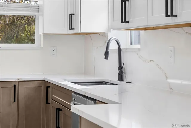 a kitchen with a sink and cabinets