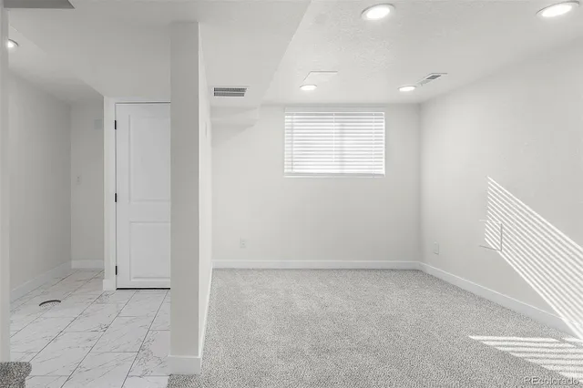 an empty room with a empty space and windows