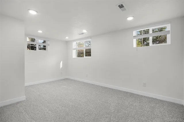 an empty room with a window and a projector