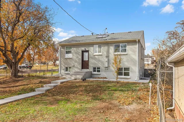 a view of a house with a yard patio and fire pit
