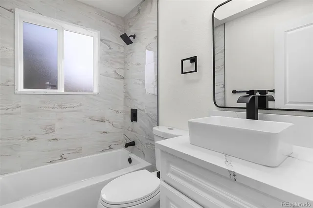 a bathroom with a toilet and a bathtub
