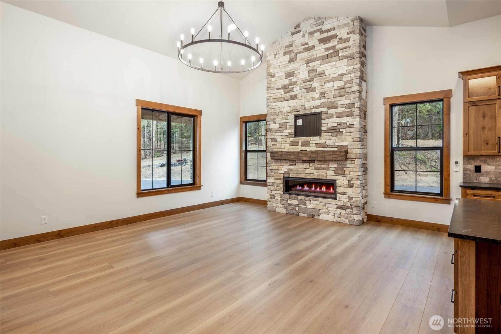 110 Bitterroot Lane Ronald, WA 98940 - Photo 10 of 28 a view of an empty room with wooden floor fireplace and a window