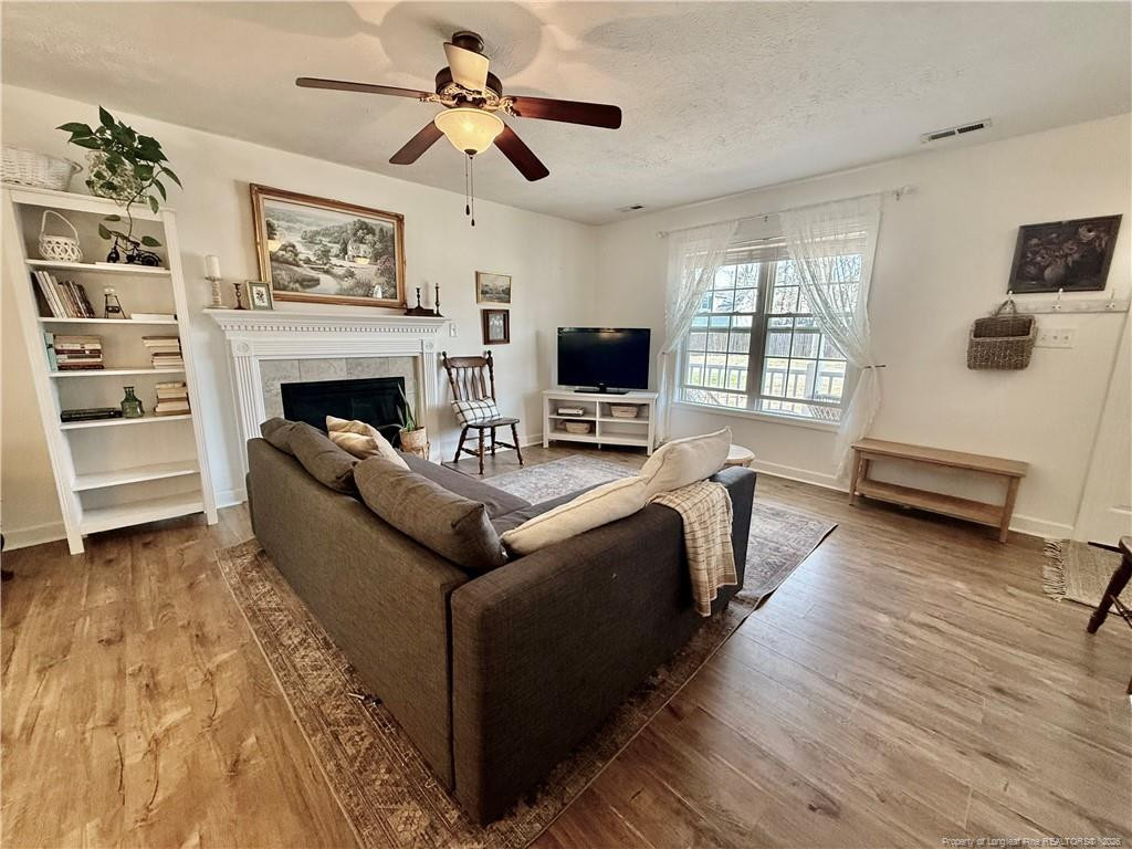 234 Pender Road Spring Lake, NC 28390 - Photo 6 of 39 a living room with furniture and a flat screen tv