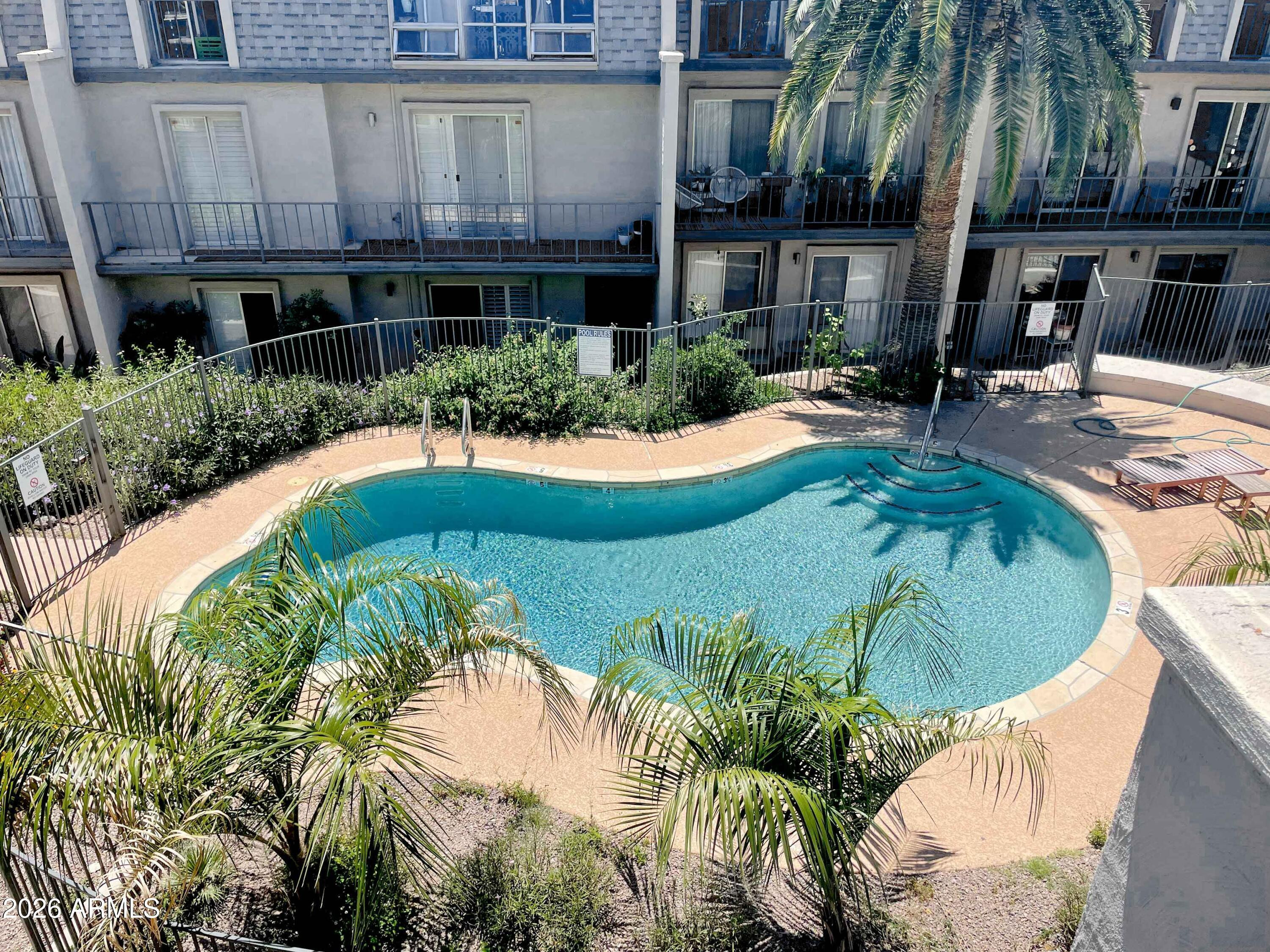 1016 East Osborn Road, Unit F Phoenix, AZ 85014 - Photo 11 of 14 a swimming pool with outdoor seating and yard