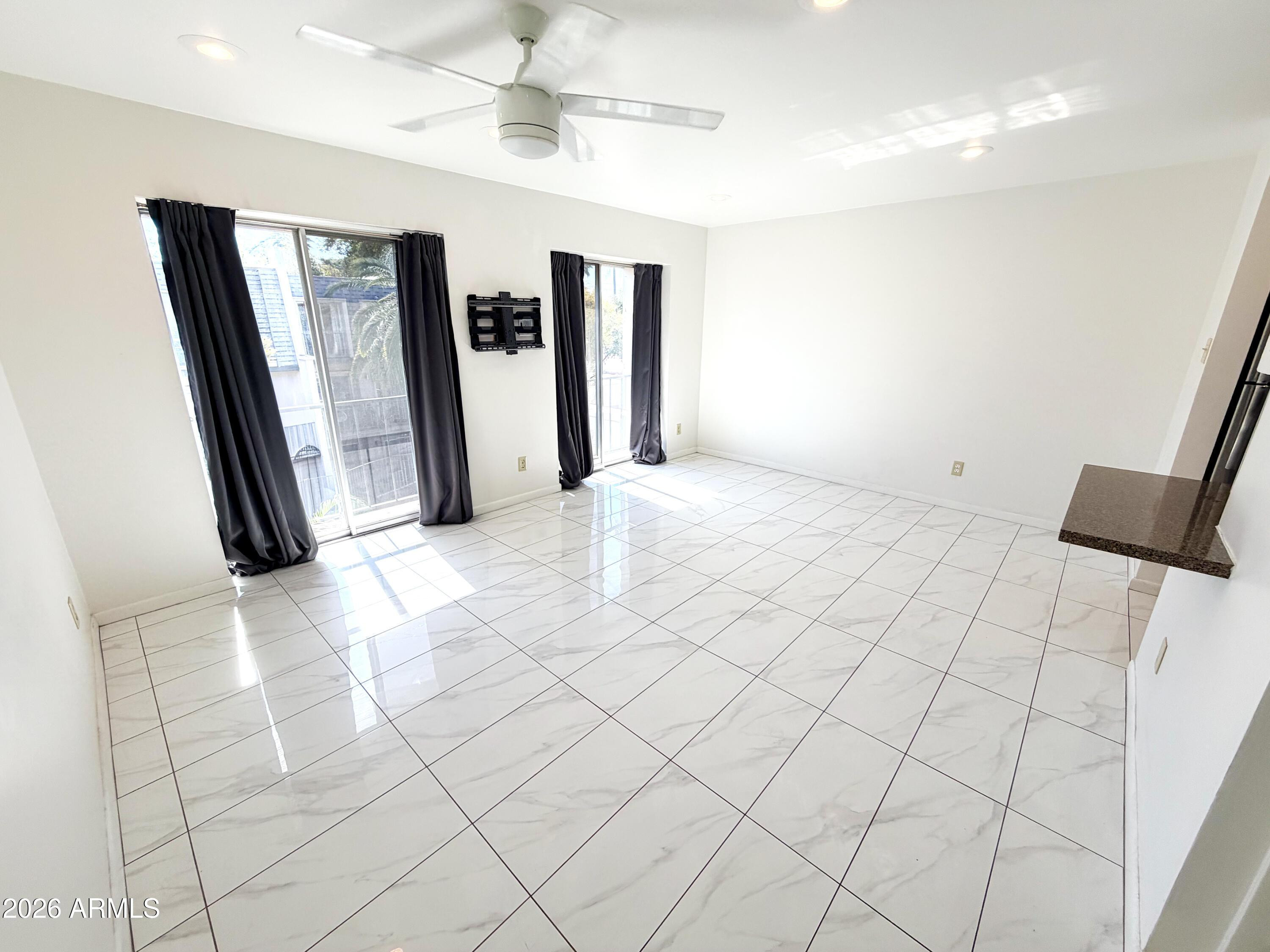1016 East Osborn Road, Unit F Phoenix, AZ 85014 - Photo 4 of 14 a view of a livingroom with a furniture and floor to ceiling window
