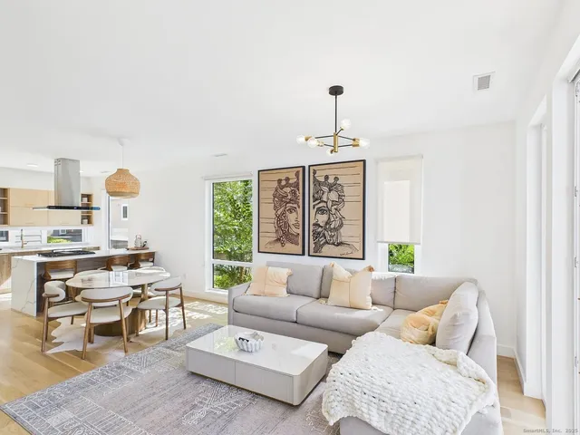 a living room with furniture a window and a table