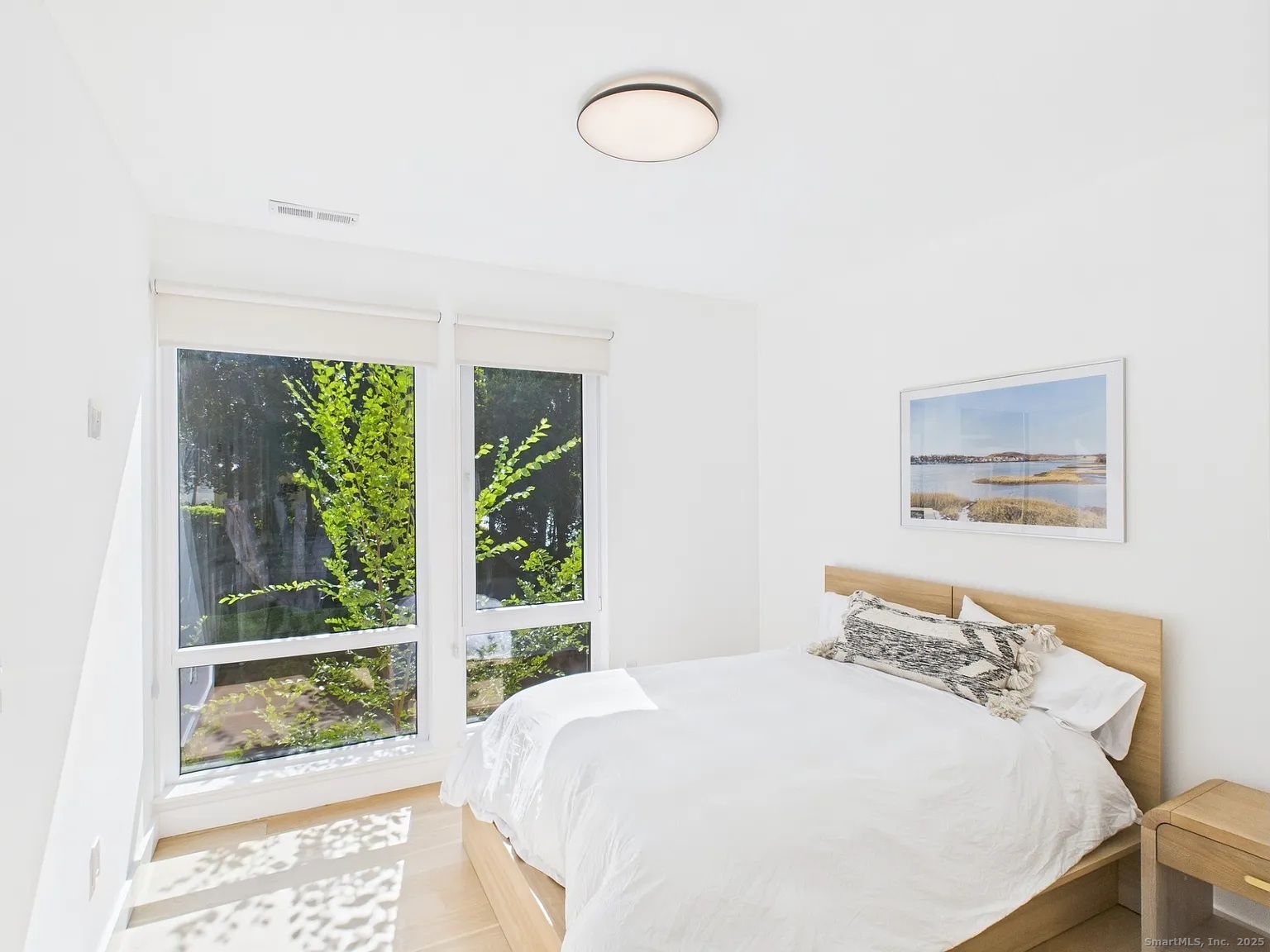 904 Quinnipiac Avenue, Unit 3 New Haven, CT 06513 - Photo 8 of 19 a bedroom with a bed and a large window