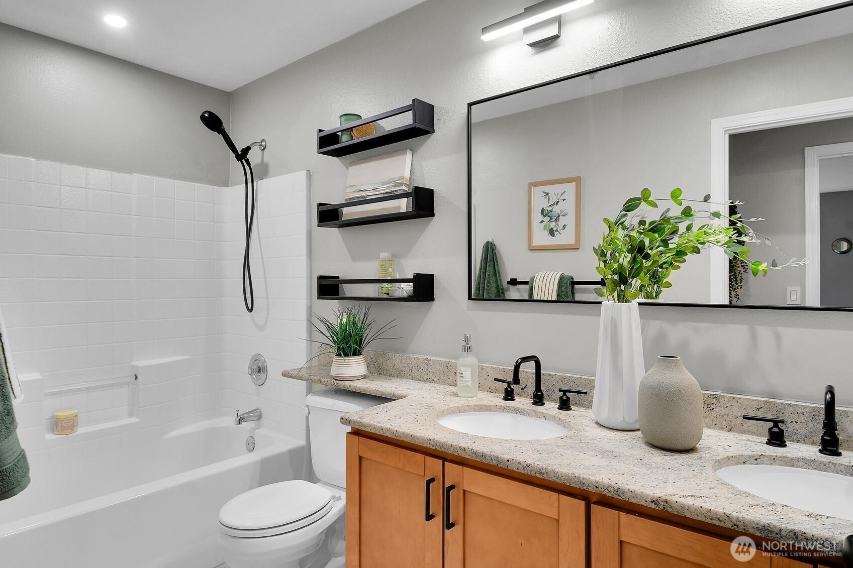 18930 Bothell Everett Highway, Unit F305 Bothell, WA 98012 - Photo 12 of 20 a bathroom with a granite countertop sink a toilet and shower