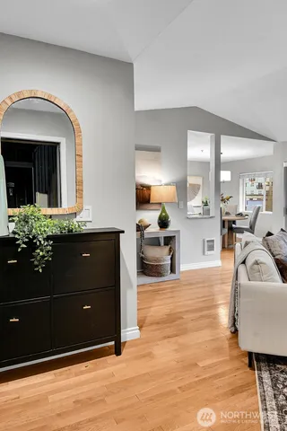 a living room with furniture and a mirror