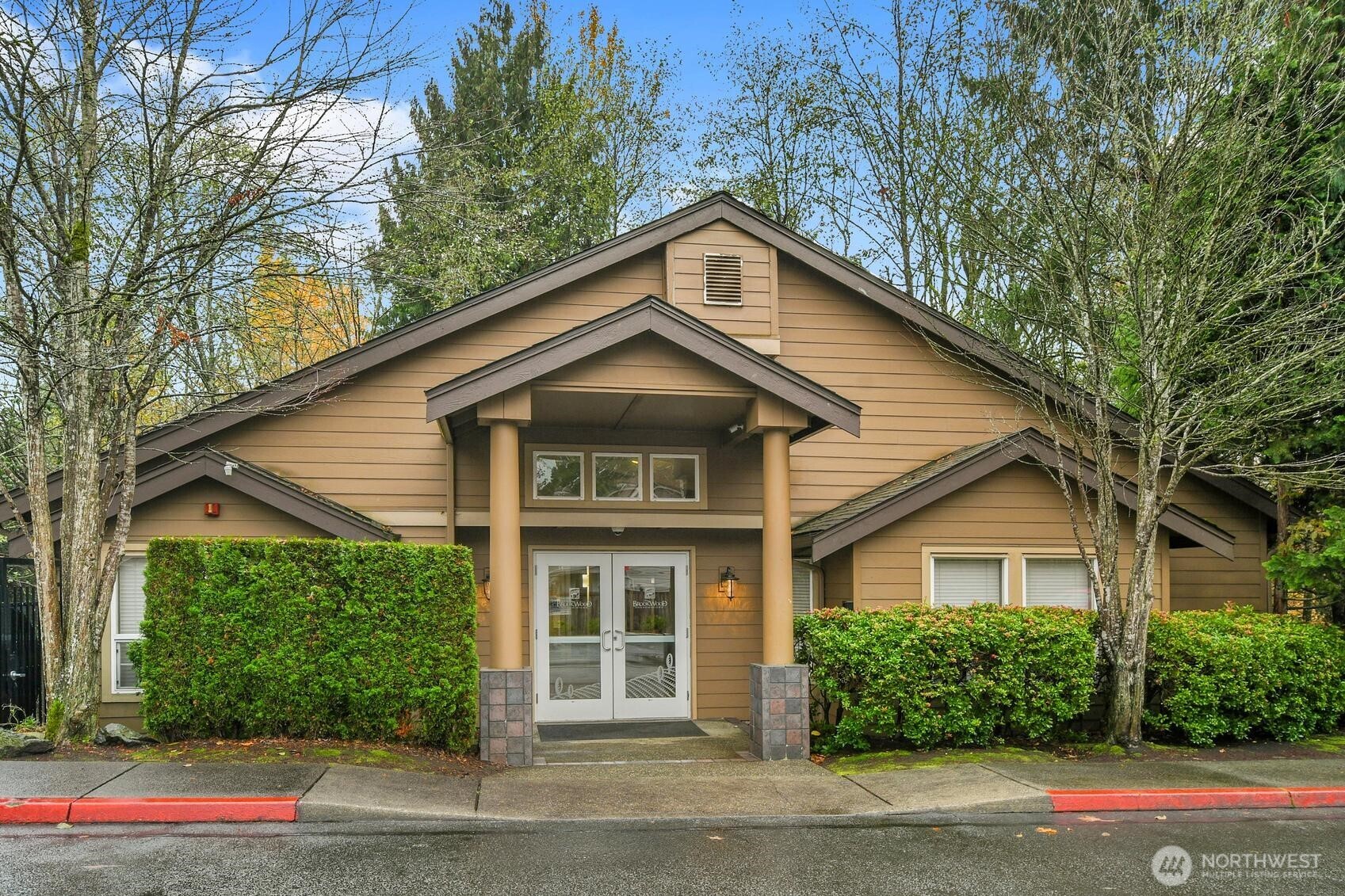 18930 Bothell Everett Highway, Unit F305 Bothell, WA 98012 - Photo 18 of 20 a front view of a house with a yard